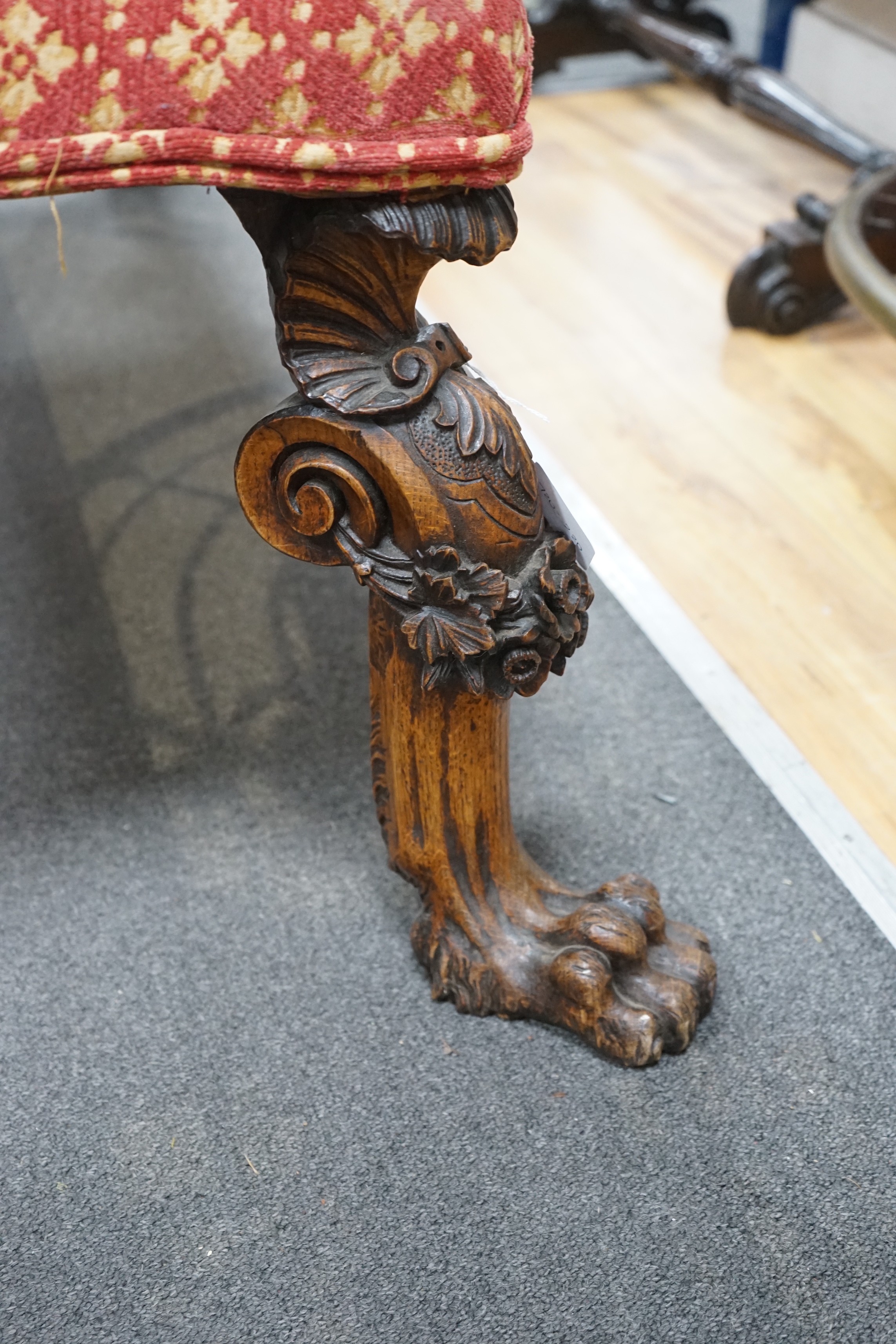 A Victorian window seat with carved oak lions paw feet, length 140cm, depth 62cm, height 48cm